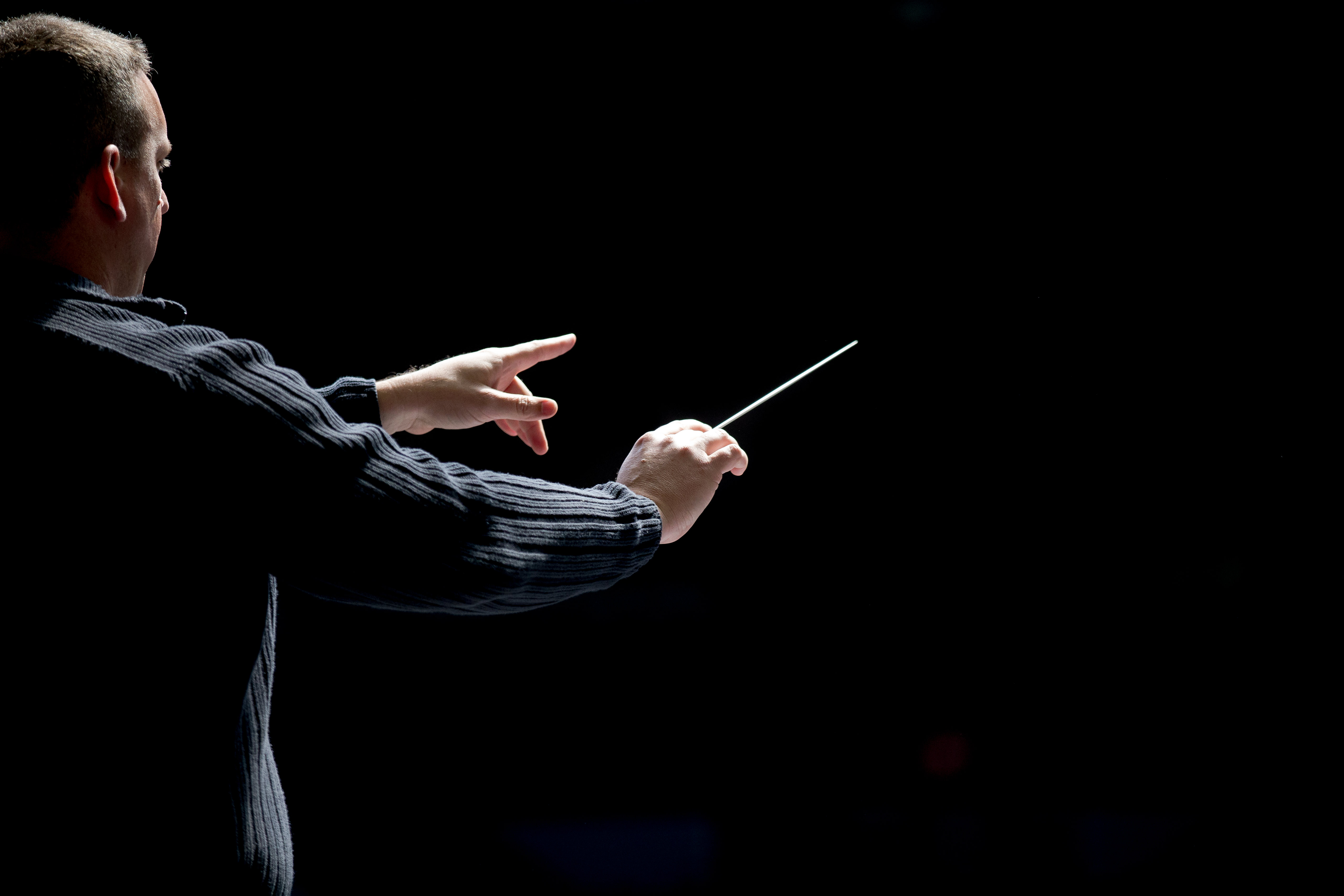 music conductor on dark background